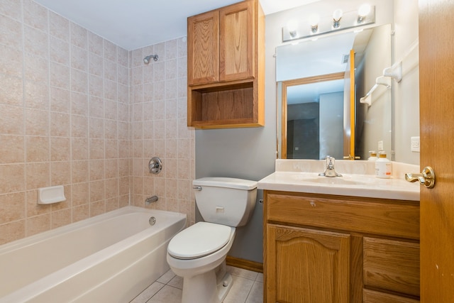 full bathroom featuring toilet, vanity, tiled shower / bath, and tile patterned flooring