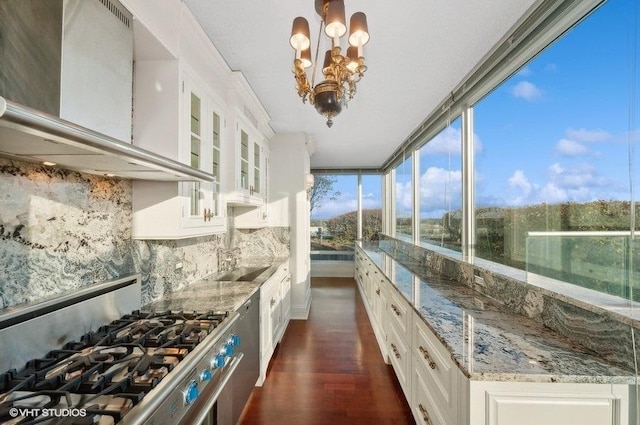 9715 Woods Dr Unit 1902, Skokie, IL 60077 - kitchen featuring stainless steel gas range oven, wall chimney range hood, white cabinetry, dark wood-style floors, and light stone countertops