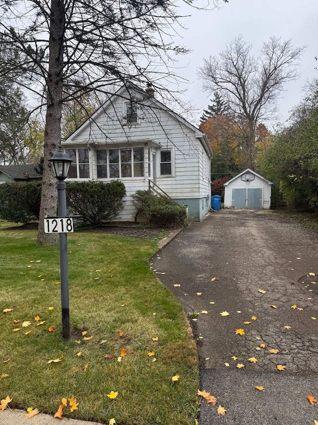 view of front facade with a storage shed and a front yard