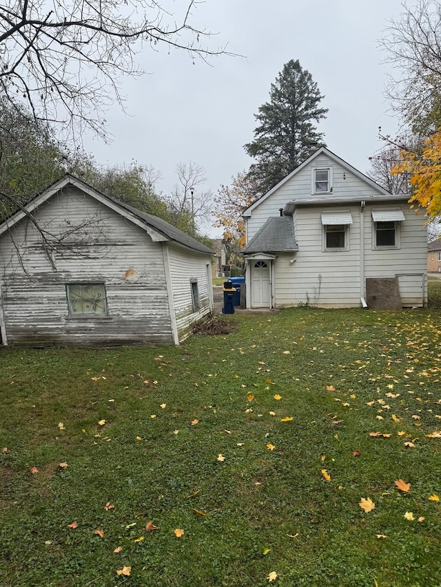 back of property with a lawn