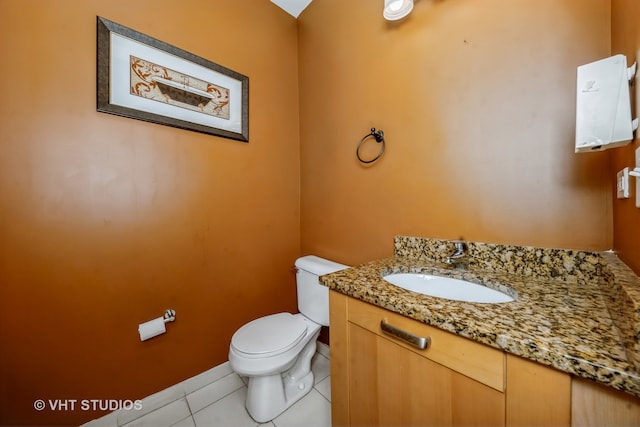 bathroom with vanity, tile patterned floors, and toilet