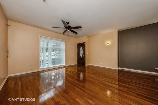 spare room with wood-type flooring and ceiling fan