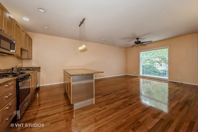 kitchen featuring a kitchen island, hanging light fixtures, dark hardwood / wood-style floors, and stainless steel appliances