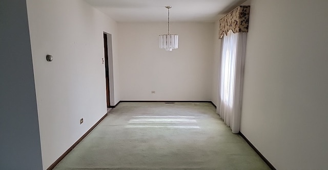 unfurnished dining area featuring light colored carpet and a notable chandelier