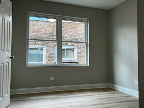 unfurnished room with light hardwood / wood-style floors