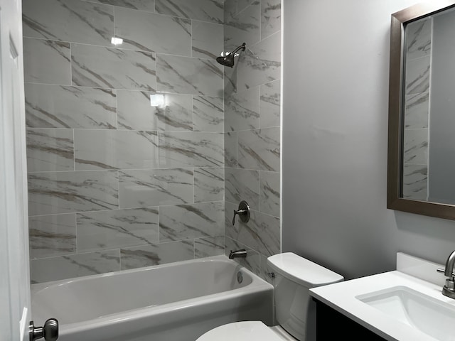 full bathroom with toilet, tiled shower / bath combo, and vanity