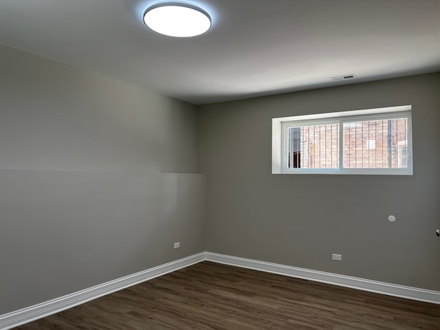 empty room with dark wood-type flooring