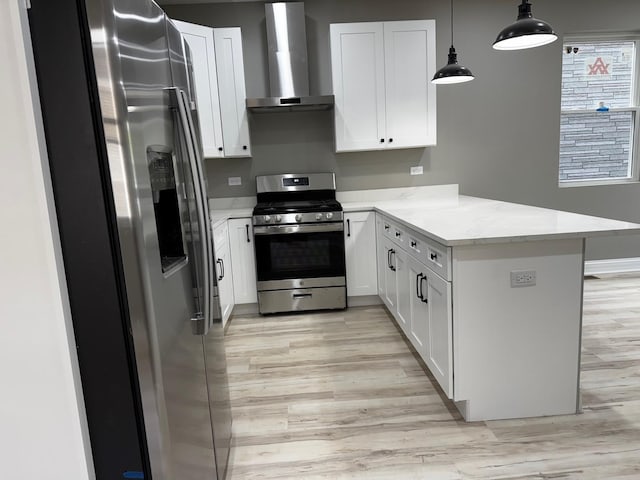 kitchen with wall chimney range hood, a peninsula, stainless steel appliances, and light wood-style floors