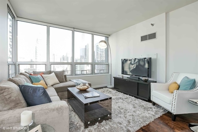 living room with a wall of windows, plenty of natural light, and dark wood-type flooring