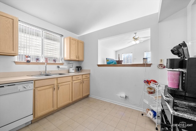 kitchen featuring sink, white dishwasher, light brown cabinets, ceiling fan, and vaulted ceiling