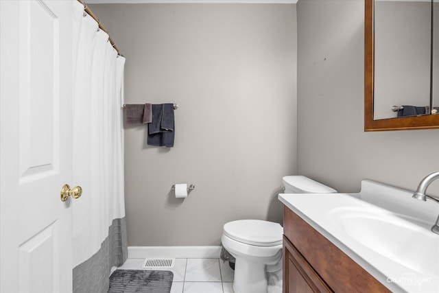 bathroom featuring toilet, vanity, and tile patterned flooring