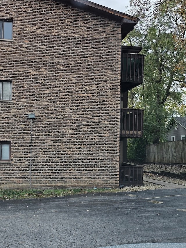 view of side of home with a balcony