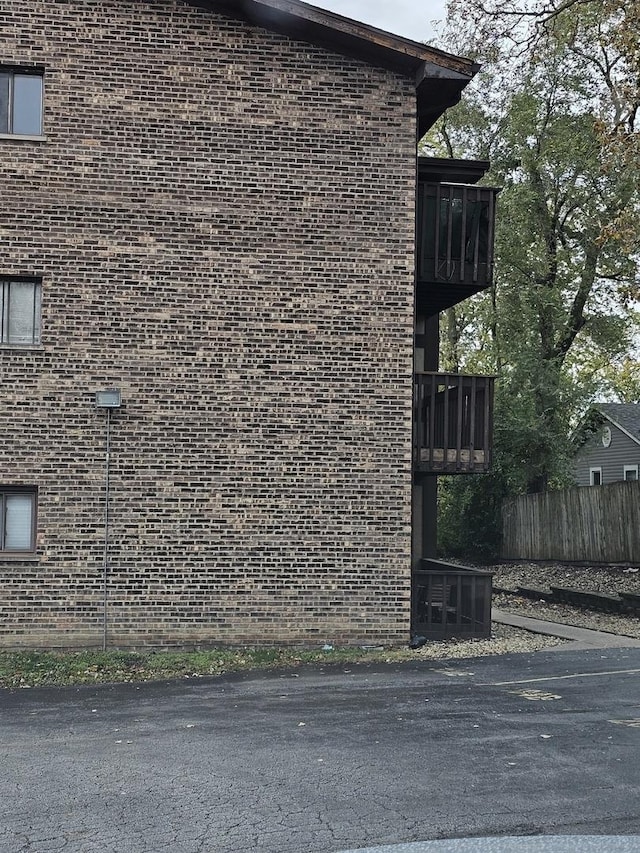 3680 W 119th St Unit 102B, Alsip, IL 60803 - view of home's exterior featuring brick siding, a balcony, and central AC unit