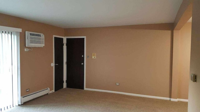 carpeted spare room featuring a wall mounted air conditioner and a baseboard heating unit