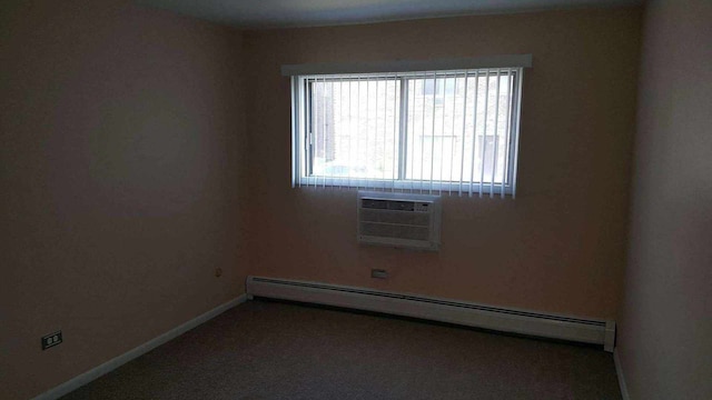 empty room featuring a baseboard heating unit and a wall mounted air conditioner