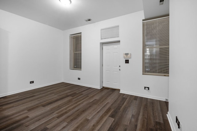 empty room with dark wood-type flooring