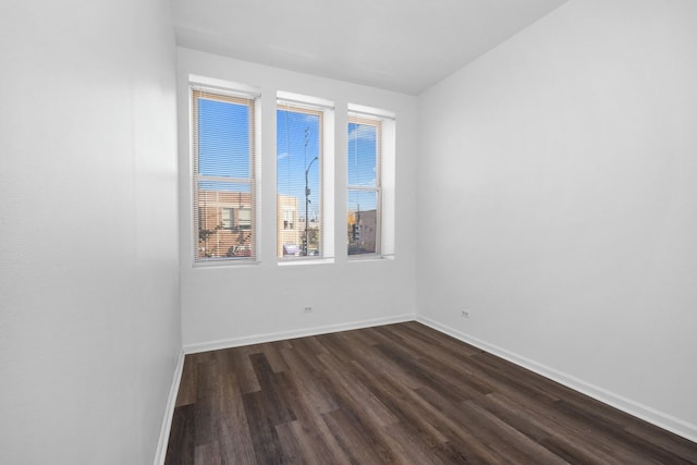 spare room featuring dark hardwood / wood-style flooring