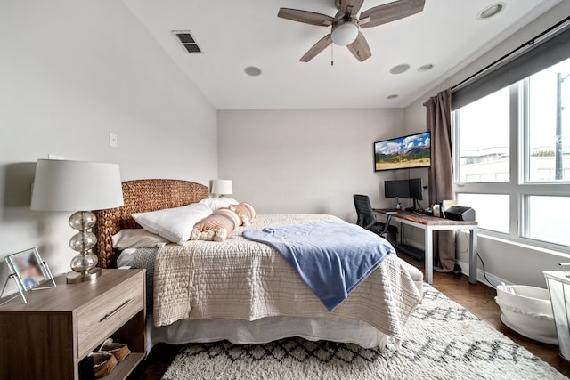 bedroom with dark wood-type flooring, vaulted ceiling, and ceiling fan