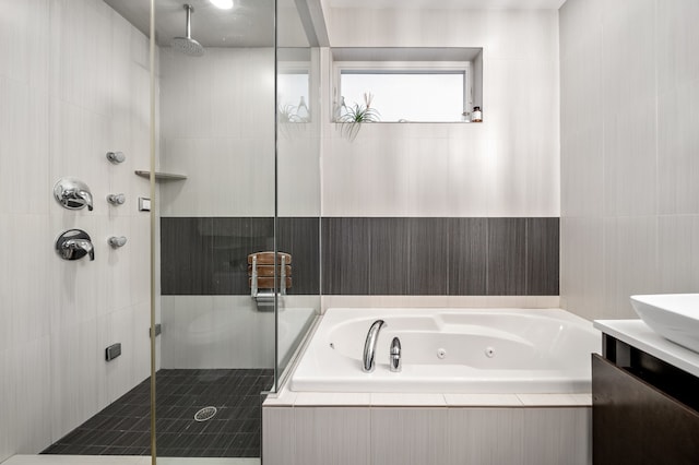 bathroom featuring vanity and plus walk in shower