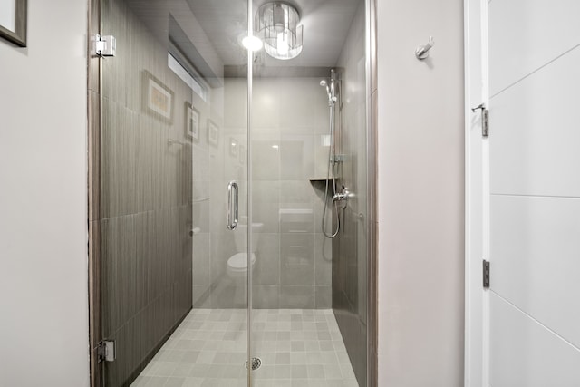 bathroom with toilet and an enclosed shower