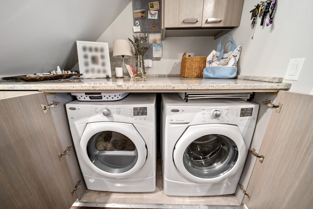 laundry room featuring cabinets and washing machine and clothes dryer