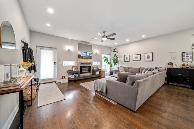 living room featuring dark hardwood / wood-style floors and ceiling fan