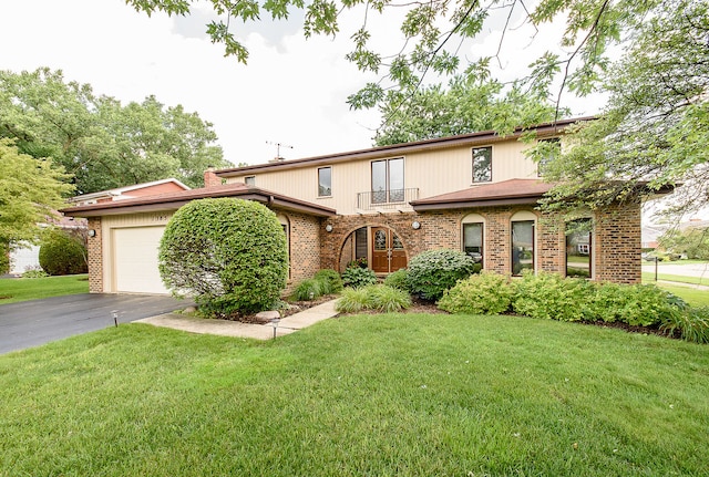 1385 Montgomery Dr, Deerfield, IL 60015 - view of front of home featuring brick siding, a front lawn, asphalt driveway, and an attached garage