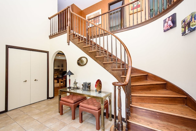 1385 Montgomery Dr, Deerfield, IL 60015 - stairway with arched walkways, a high ceiling, and tile patterned floors