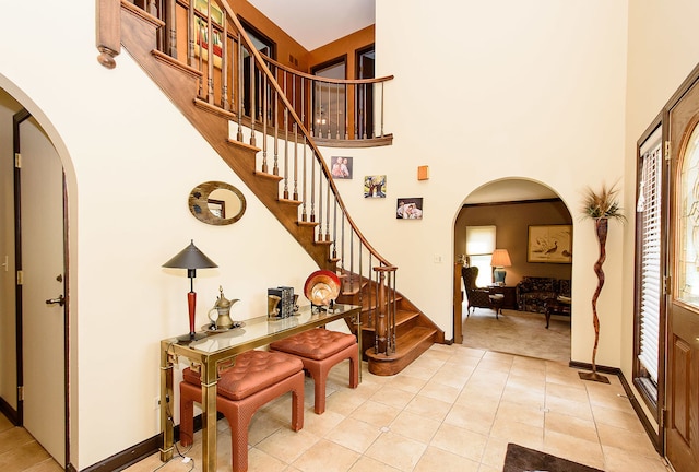 1385 Montgomery Dr, Deerfield, IL 60015 - foyer entrance with stairway, arched walkways, light tile patterned floors, and a towering ceiling