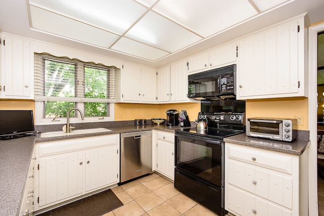 1385 Montgomery Dr, Deerfield, IL 60015 - kitchen featuring black appliances, dark countertops, light tile patterned floors, and white cabinetry