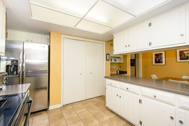 1385 Montgomery Dr, Deerfield, IL 60015 - kitchen featuring black range with electric stovetop, dark countertops, light tile patterned floors, and stainless steel fridge with ice dispenser