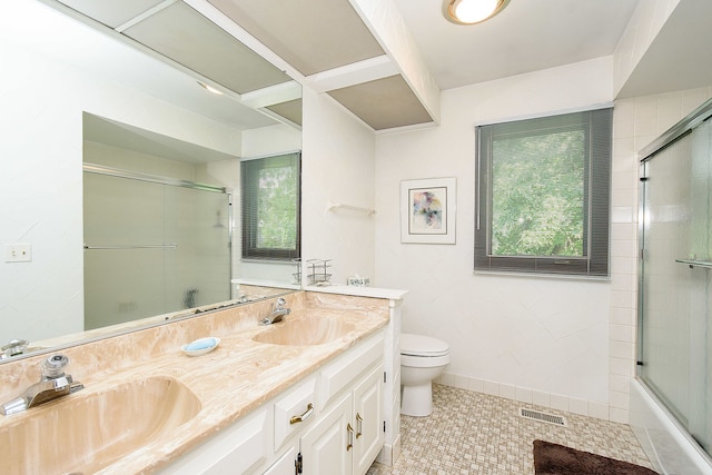 1385 Montgomery Dr, Deerfield, IL 60015 - full bathroom with healthy amount of natural light, double vanity, combined bath / shower with glass door, and tile patterned floors