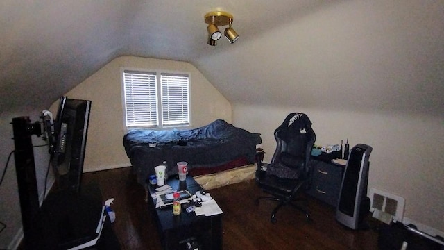 bedroom featuring dark hardwood / wood-style flooring and vaulted ceiling