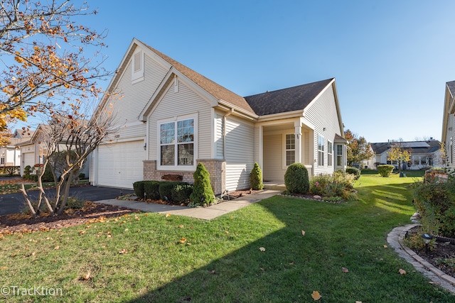 view of front of home featuring a front yard and a garage