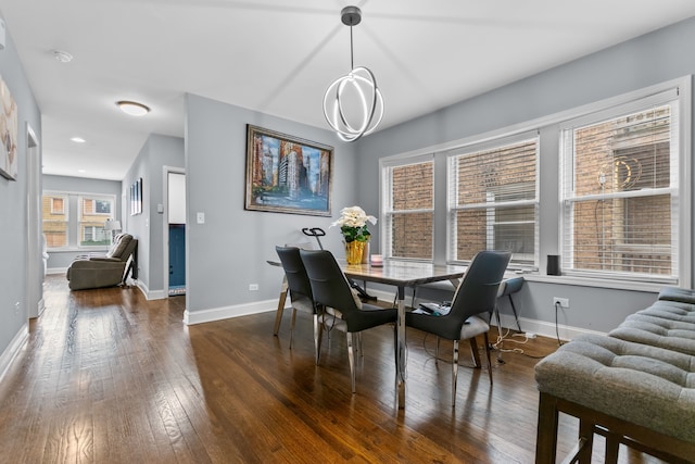 dining room featuring dark wood-type flooring and a wealth of natural light