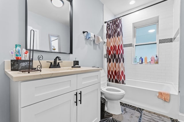 full bathroom featuring vanity, shower / bath combo, and toilet