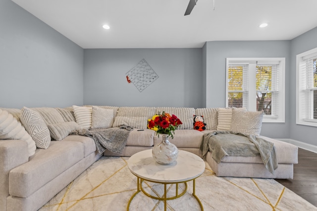 living room featuring hardwood / wood-style flooring and ceiling fan