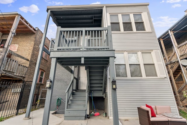 back of house featuring a balcony