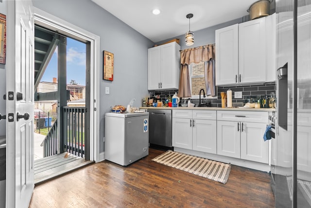 kitchen featuring a healthy amount of sunlight, white cabinetry, stainless steel dishwasher, and fridge