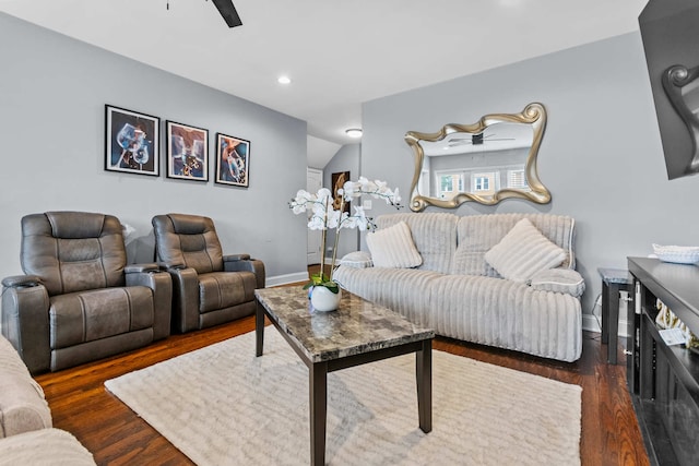 living room with ceiling fan and dark wood-type flooring