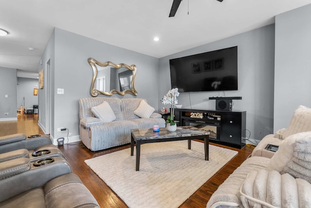 living room with ceiling fan and dark hardwood / wood-style flooring