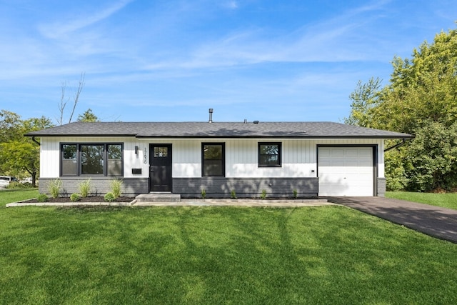 view of front of property featuring a garage and a front lawn