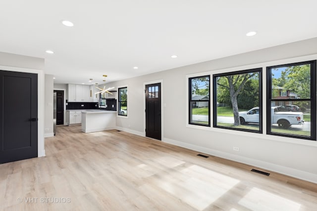 unfurnished living room with light hardwood / wood-style floors