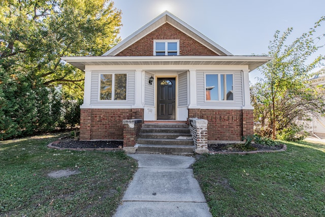 bungalow-style house with a front yard