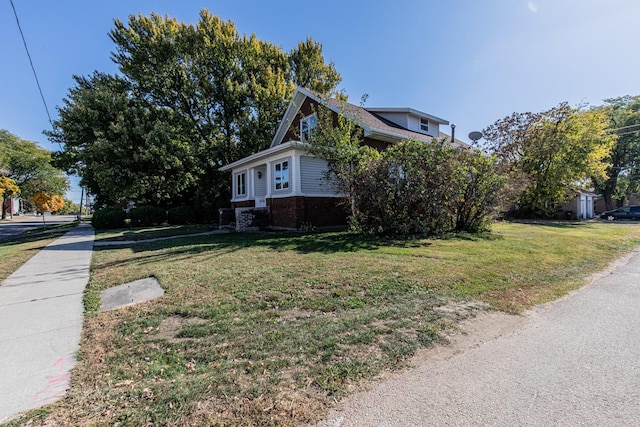 111 E 3rd St, Prophetstown, IL 61277 - view of home's exterior with a yard and brick siding