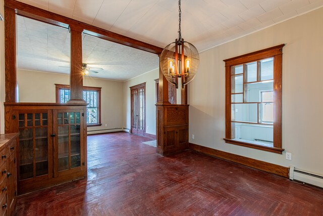 unfurnished dining area with baseboard heating, ceiling fan with notable chandelier, and dark wood-type flooring