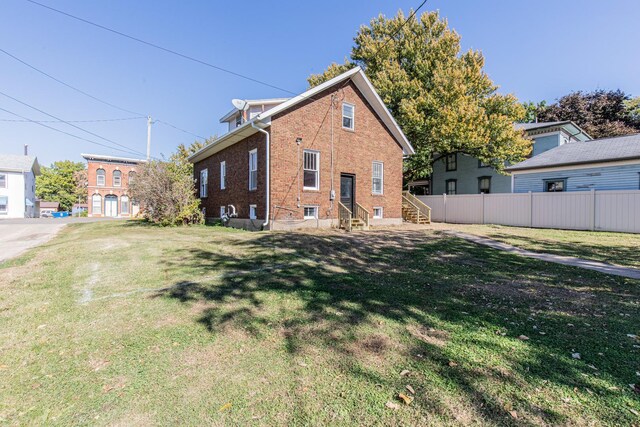 111 E 3rd St, Prophetstown, IL 61277 - back of property featuring brick siding and entry steps