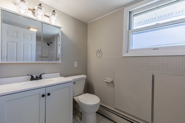 bathroom featuring tile patterned floors, toilet, tile walls, ornamental molding, and vanity