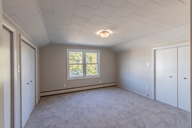 bonus room with lofted ceiling, light colored carpet, and a baseboard radiator