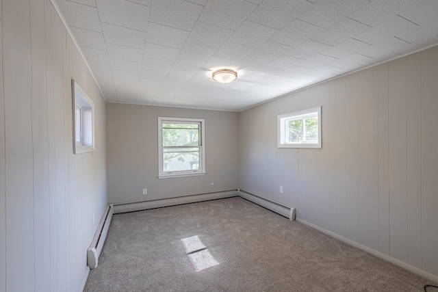 111 E 3rd St, Prophetstown, IL 61277 - carpeted spare room featuring healthy amount of natural light, baseboards, a baseboard heating unit, and wood walls